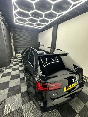Rear quarter panel of a black Audi Avant showing high-gloss paint protection