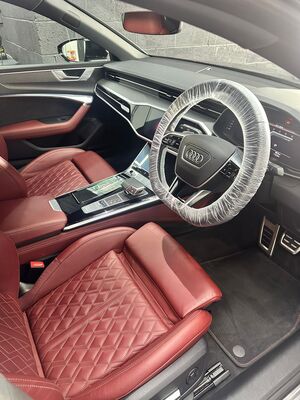 Luxury Audi interior featuring detailed red leather seats and clean dashboard