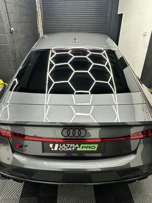 Grey Audi S7 rear bumper and paintwork reflecting studio lighting