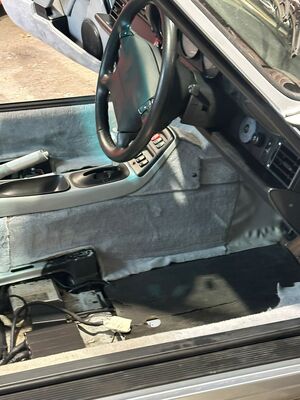 Immaculate grey carpet and detailed center console of a classic Porsche 911