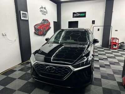 Black Hyundai SUV front grille and bumper after paint correction and detailing