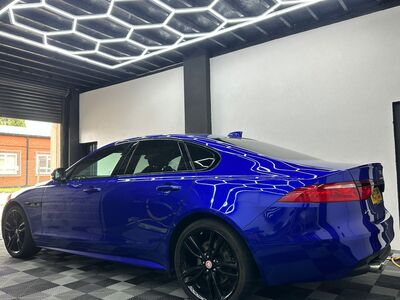 Polished blue Jaguar XE side profile after professional car detailing in Liverpool