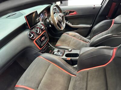 Deep cleaned black leather car seat with red contrast stitching