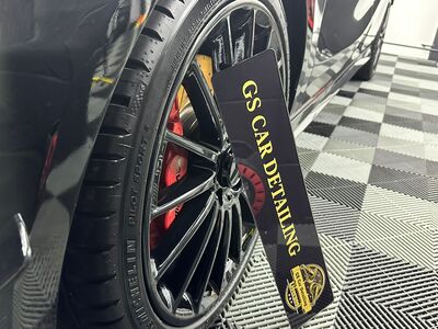 Multi-spoke alloy wheel with red brake calipers detailed and cleaned