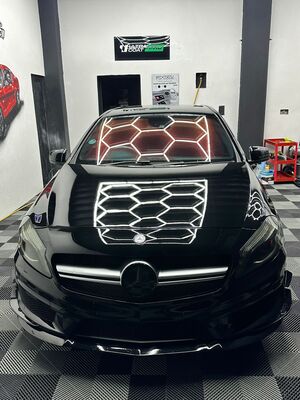 Bonnet reflection of hexagonal lighting on a black Mercedes A-Class after paint correction in Liverpool