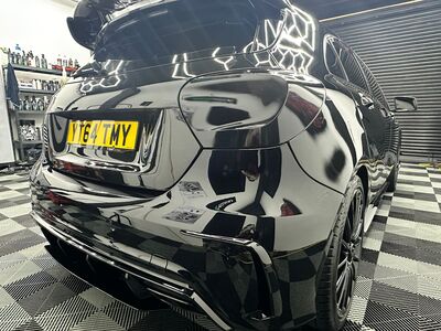 Close-up of the rear taillight and polished panel on a black Mercedes-Benz A-Class