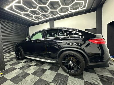 Polished side profile of a black Mercedes-Benz GLC Coupe in our studio