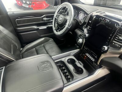 Detailed leather steering wheel, dashboard, and front seats of a RAM truck