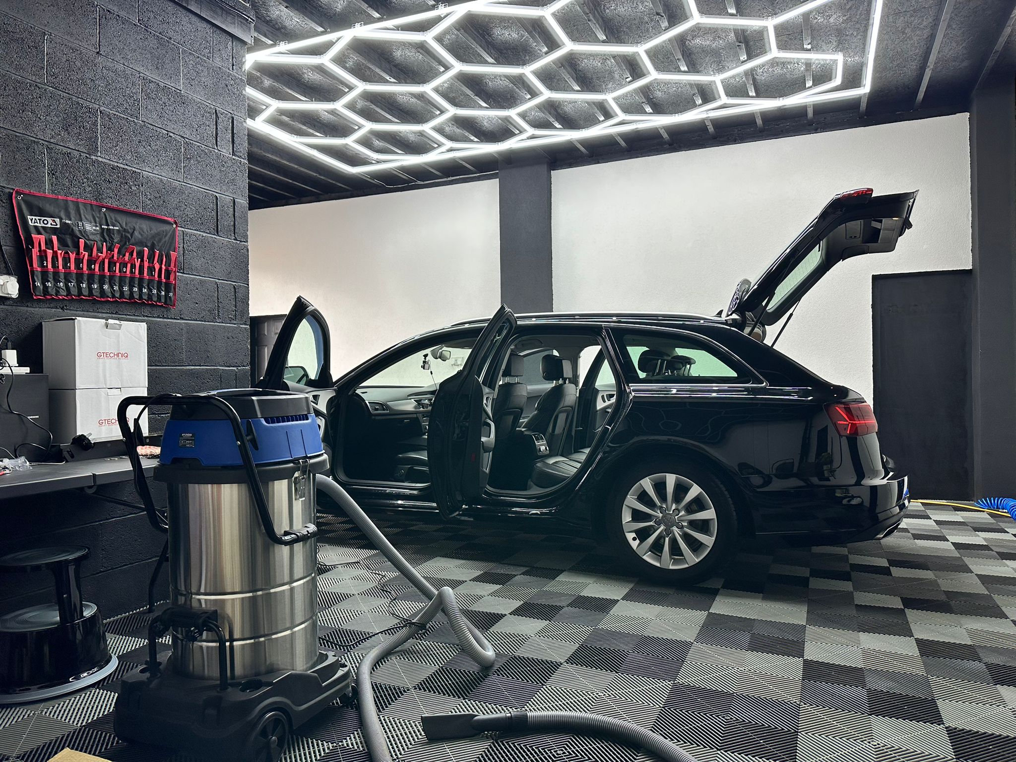 Luxury sports car being machine polished in our clean, professional car detailing studio in Liverpool